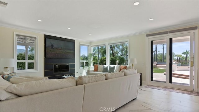 living room featuring a large fireplace, ornamental molding, recessed lighting, and light marble finish floors