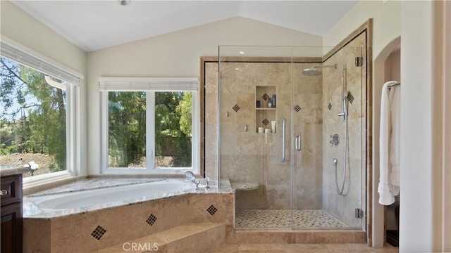 bathroom featuring a bath, a shower stall, and lofted ceiling