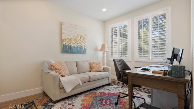 office space featuring baseboards, wood finished floors, and recessed lighting