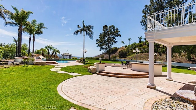 view of green lawn featuring a patio area and an outdoor pool