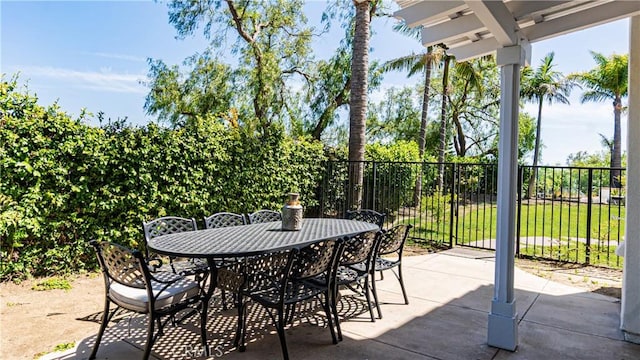 view of patio / terrace featuring fence and outdoor dining space