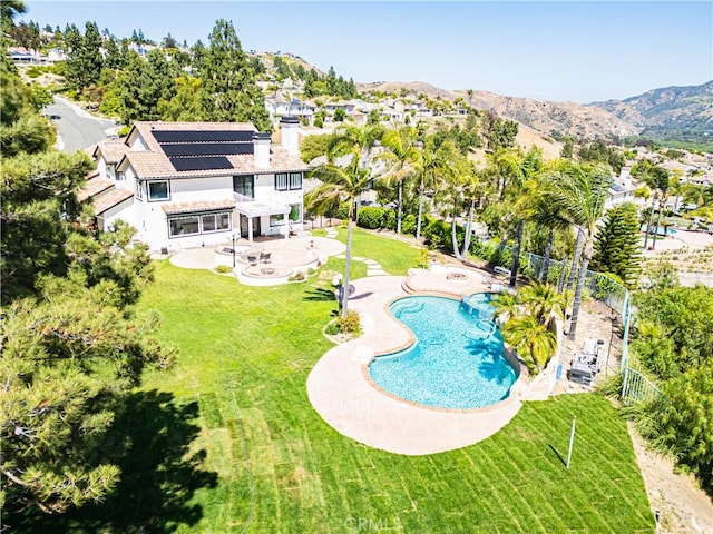 outdoor pool with a patio and a mountain view