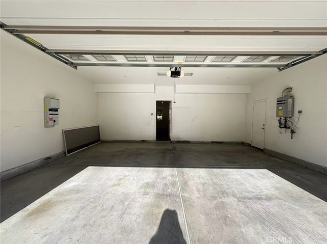 garage featuring a garage door opener and water heater