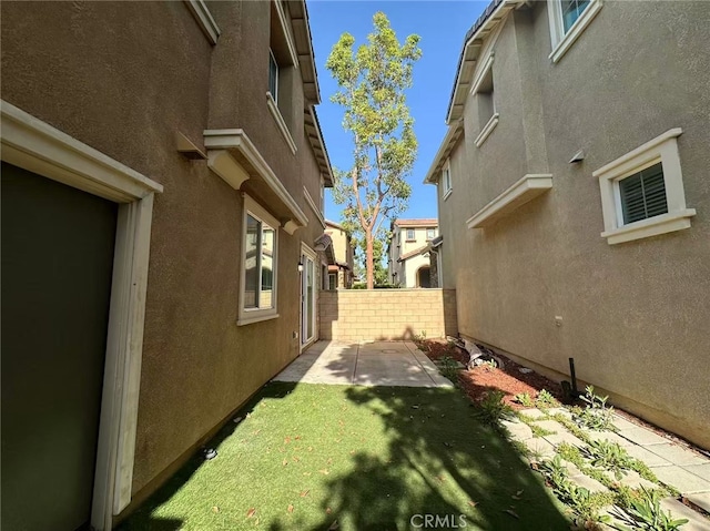 view of yard with fence and a patio