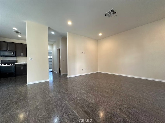 unfurnished room featuring dark wood finished floors, baseboards, and recessed lighting