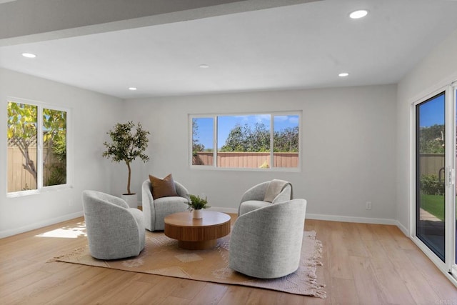 sitting room with plenty of natural light, light wood-style floors, recessed lighting, and baseboards