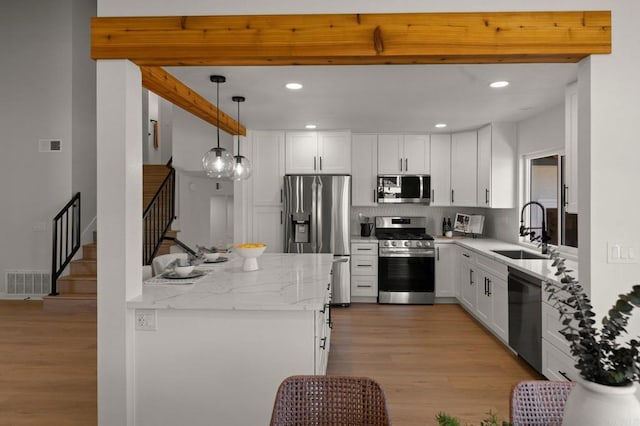 9142 Ellingham St, San Diego, CA 92129 - kitchen featuring stainless steel appliances, a sink, light wood-type flooring, backsplash, and white cabinetry