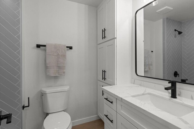 9142 Ellingham St, San Diego, CA 92129 - bathroom with vanity, toilet, a shower, baseboards, and wood finished floors