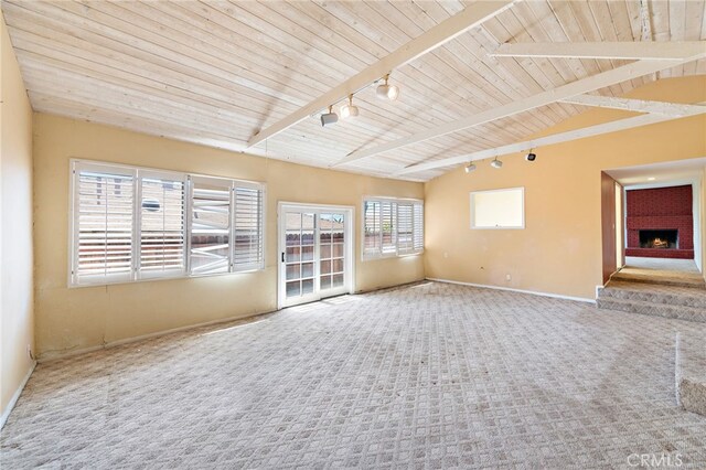 104 W Avenida Cadiz, San Clemente, CA 92672 - empty room featuring carpet, rail lighting, baseboards, a warm lit fireplace, and wood ceiling