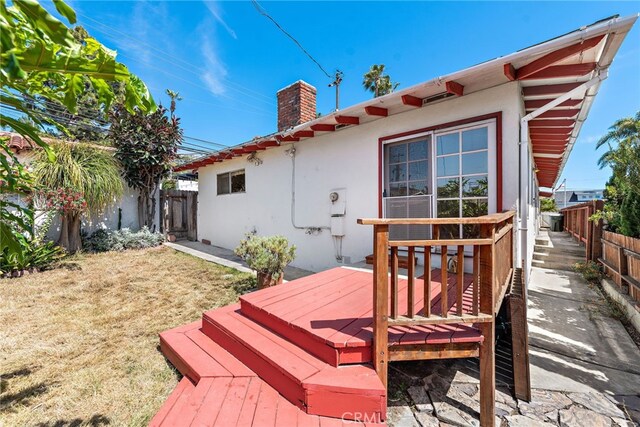 104 W Avenida Cadiz, San Clemente, CA 92672 - back of property featuring stucco siding, a chimney, a deck, and a fenced backyard