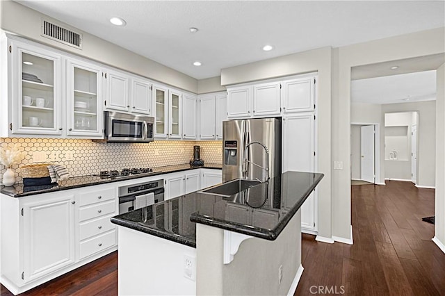 22 Amesbury Ct, Ladera Ranch, CA 92694 - kitchen featuring appliances with stainless steel finishes, dark wood-type flooring, white cabinets, decorative backsplash, and recessed lighting