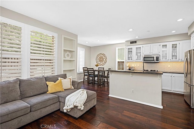 22 Amesbury Ct, Ladera Ranch, CA 92694 - living room with dark wood-style floors, plenty of natural light, recessed lighting, built in features, and baseboards