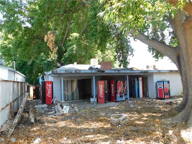8553 Chimineas Ave, Northridge, CA 91325 - rear view of house featuring fence, a chimney, and stucco siding