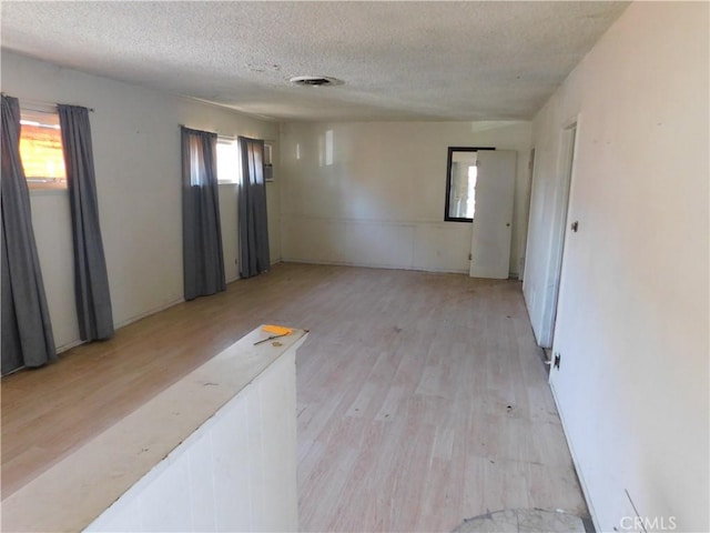 8553 Chimineas Ave, Northridge, CA 91325 - spare room featuring a textured ceiling and light wood-style floors
