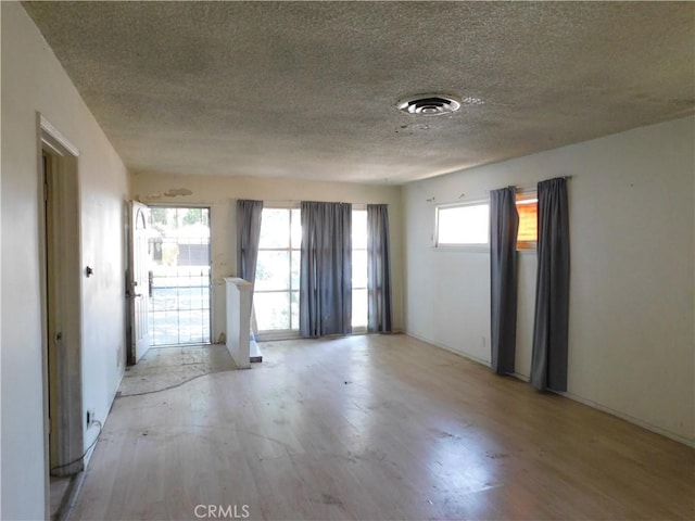8553 Chimineas Ave, Northridge, CA 91325 - empty room with a textured ceiling and light wood-style floors