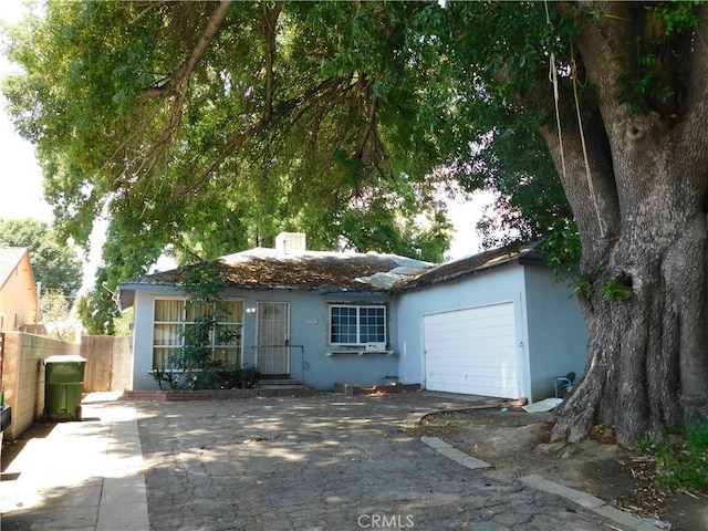 8553 Chimineas Ave, Northridge, CA 91325 - ranch-style house featuring stucco siding, fence, and a garage