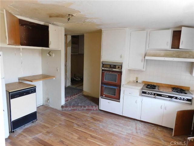 8553 Chimineas Ave, Northridge, CA 91325 - kitchen with white dishwasher, stovetop, light wood-style floors, double oven, and under cabinet range hood