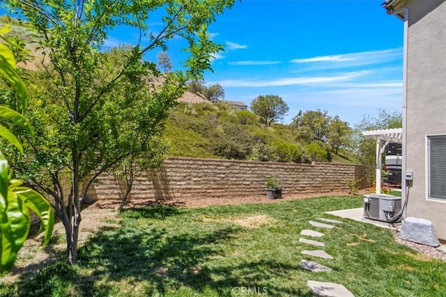 view of yard featuring central AC and a pergola