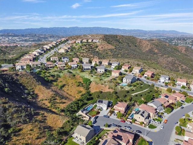 aerial view of property and surrounding area with mountains and nearby suburban area