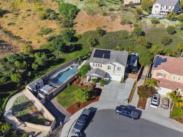 aerial overview of property's location with a pool and nearby suburban area