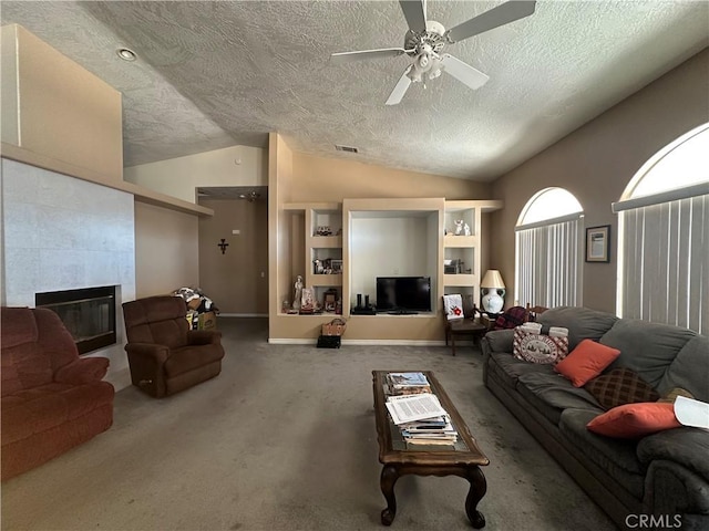 15360 Mandan Rd, Apple Valley, CA 92307 - carpeted living room with vaulted ceiling, a textured ceiling, a ceiling fan, a fireplace, and baseboards
