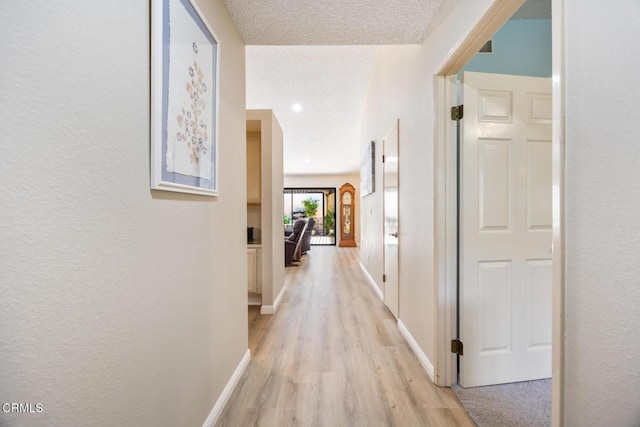 286 W Montecito Ave Unit K, Sierra Madre, CA 91024 - hall featuring light wood-style flooring, baseboards, a textured ceiling, and a textured wall