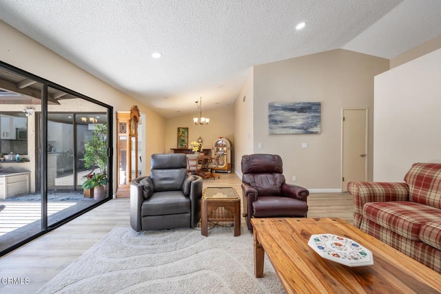 286 W Montecito Ave Unit K, Sierra Madre, CA 91024 - living room featuring a chandelier, light wood finished floors, vaulted ceiling, baseboards, and a textured ceiling