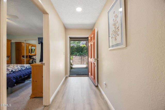 286 W Montecito Ave Unit K, Sierra Madre, CA 91024 - corridor with a textured ceiling, wood finished floors, baseboards, and a textured wall