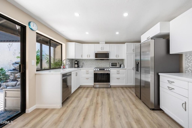 286 W Montecito Ave Unit K, Sierra Madre, CA 91024 - kitchen featuring appliances with stainless steel finishes, light wood finished floors, backsplash, white cabinets, and recessed lighting