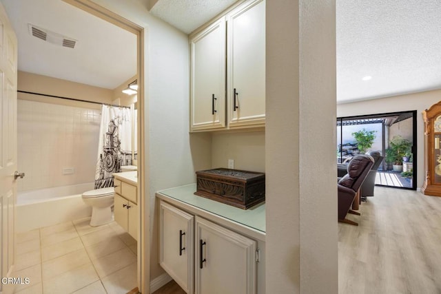 286 W Montecito Ave Unit K, Sierra Madre, CA 91024 - bathroom with vanity, toilet, a textured ceiling, shower / bath combo, and tile patterned floors