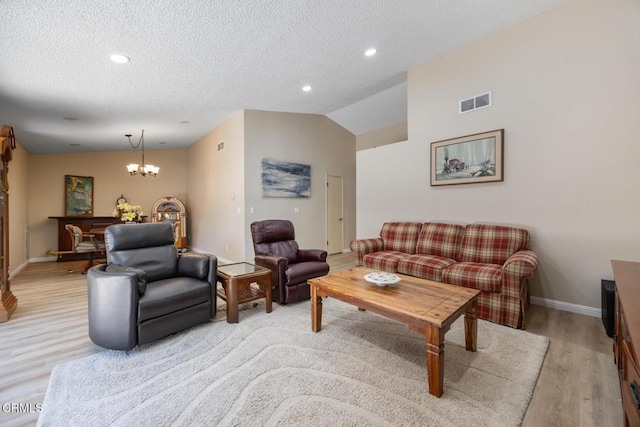 286 W Montecito Ave Unit K, Sierra Madre, CA 91024 - living area featuring light wood-style floors, baseboards, a chandelier, a textured ceiling, and vaulted ceiling