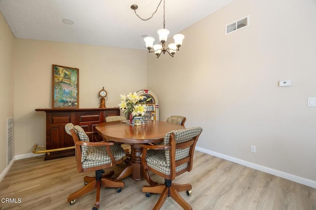286 W Montecito Ave Unit K, Sierra Madre, CA 91024 - dining room featuring a chandelier, light wood-style flooring, and baseboards