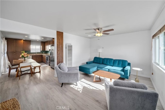 1599 21st St, Oceano, CA 93445 - living room featuring light wood-type flooring, a heating unit, a ceiling fan, and baseboards