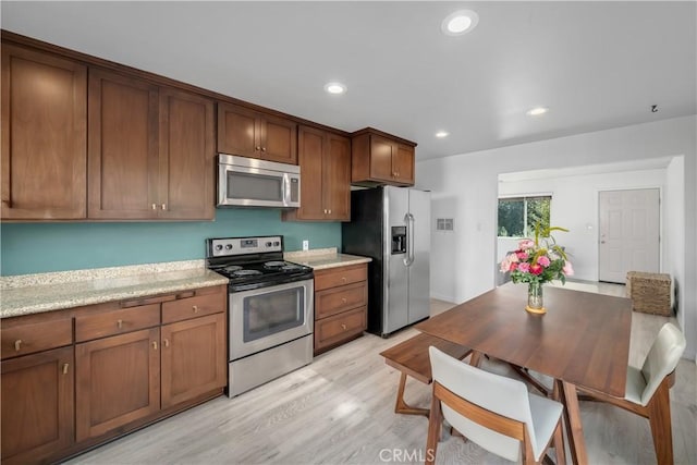 1599 21st St, Oceano, CA 93445 - kitchen with appliances with stainless steel finishes, light wood finished floors, recessed lighting, and brown cabinets