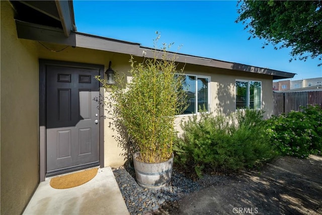 1599 21st St, Oceano, CA 93445 - view of exterior entry featuring stucco siding and fence