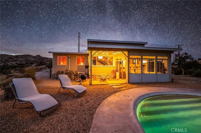 56714 Nelson Ave, Yucca Valley, CA 92284 - rear view of house featuring a patio area and a sunroom