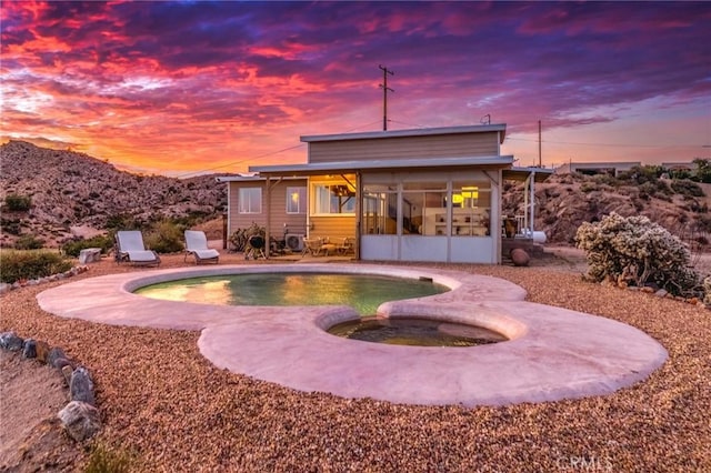 56714 Nelson Ave, Yucca Valley, CA 92284 - back of house featuring a sunroom, a patio, and a pool with connected hot tub