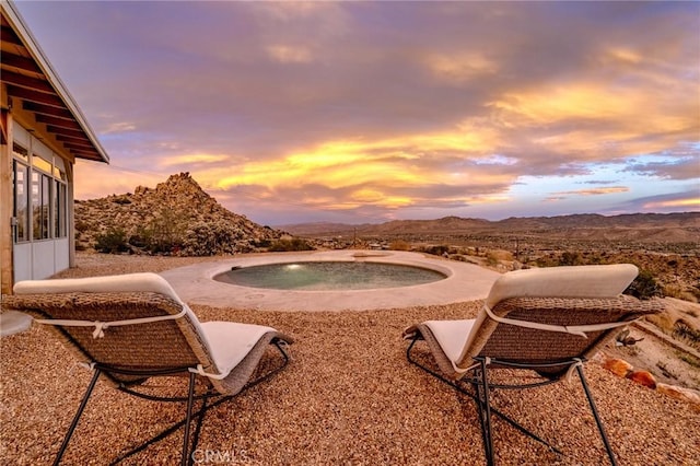 56714 Nelson Ave, Yucca Valley, CA 92284 - patio terrace at dusk featuring a mountain view and an outdoor hot tub