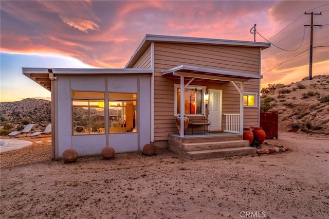 56714 Nelson Ave, Yucca Valley, CA 92284 - back of house at dusk featuring a mountain view