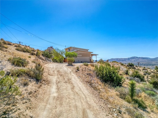 56714 Nelson Ave, Yucca Valley, CA 92284 - view of dirt / gravel driveway featuring a mountain view