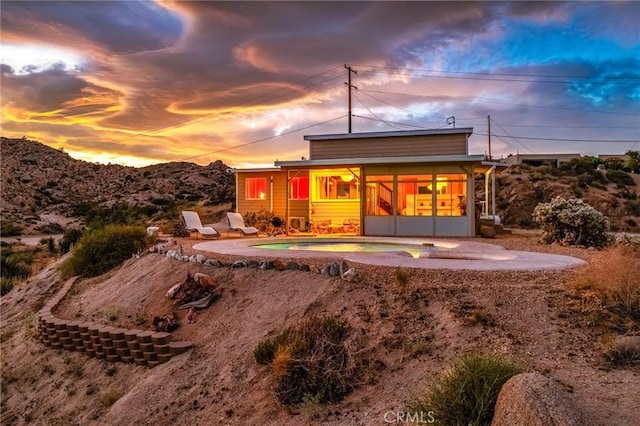 56714 Nelson Ave, Yucca Valley, CA 92284 - rear view of house with a sunroom and a patio area