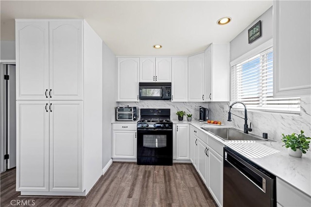 20155 Keaton St, Canyon Country, CA 91351 - kitchen featuring black appliances, a sink, dark wood-style floors, tasteful backsplash, and white cabinetry