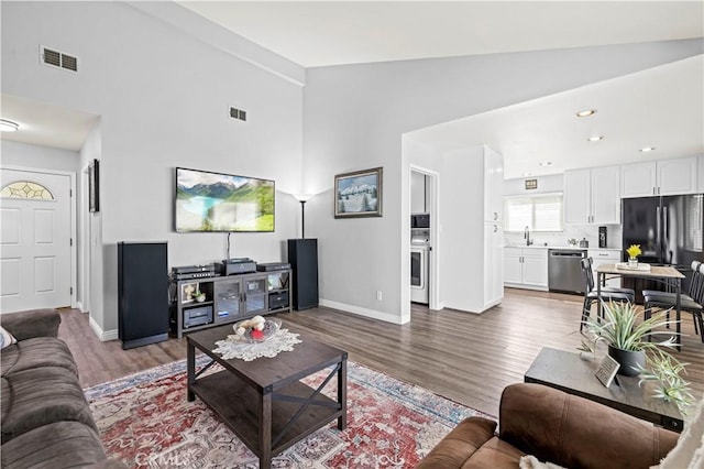 20155 Keaton St, Canyon Country, CA 91351 - living room featuring wood finished floors, high vaulted ceiling, and baseboards