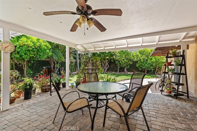 view of patio / terrace with outdoor dining space, a fenced backyard, and a ceiling fan