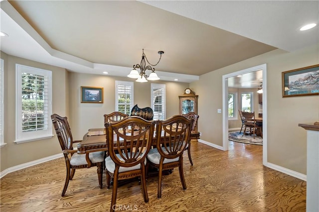 dining area featuring wood finished floors, a chandelier, recessed lighting, healthy amount of natural light, and baseboards