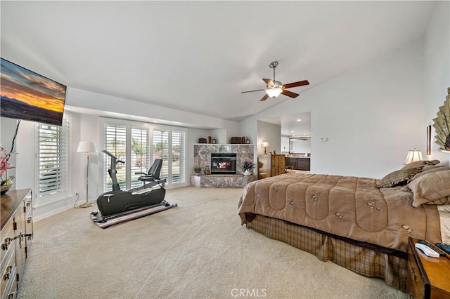 bedroom with a fireplace, vaulted ceiling, carpet floors, access to outside, and a ceiling fan