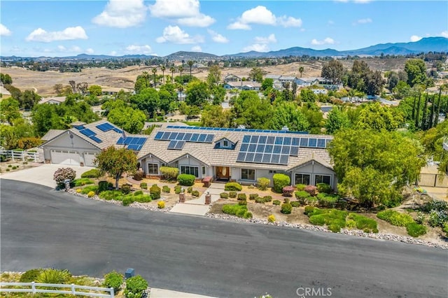 aerial view of property and surrounding area with a mountain backdrop