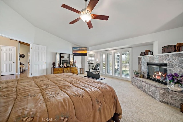 carpeted bedroom with access to exterior, a fireplace, high vaulted ceiling, and a ceiling fan