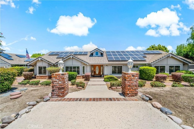 view of front of house featuring solar panels and a tile roof