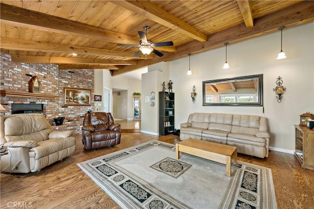 living room with wood finished floors, baseboards, a ceiling fan, wood ceiling, and beam ceiling